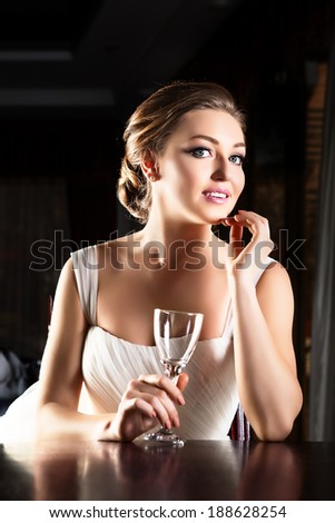 Portrait of young happy beautiful woman in restaurant.