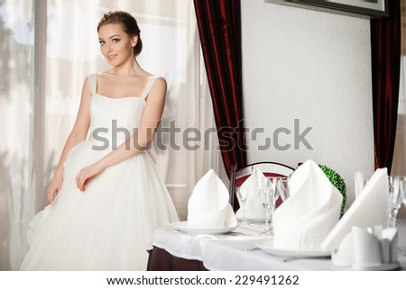 Portrait of young happy beautiful woman in restaurant.