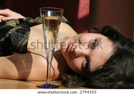 Beautiful women on wood floor with champagne glass.