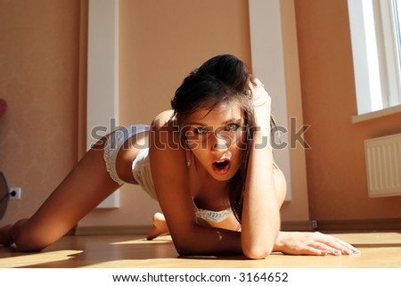Beautiful sexy woman on the wood floor.