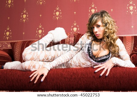 Pretty female model i on the red sofa.
