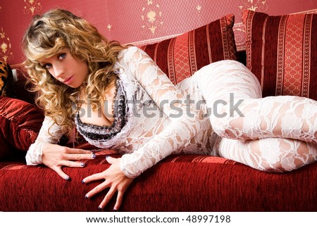 Pretty female model i on the red sofa.