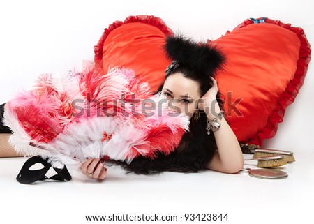 A girl with a heart in the form of cushions fan stops. Valentine's Day.