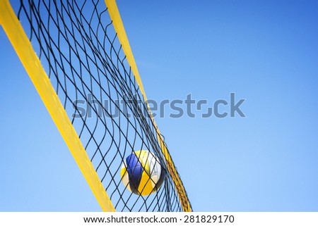 Beach volleyball caught in the net.