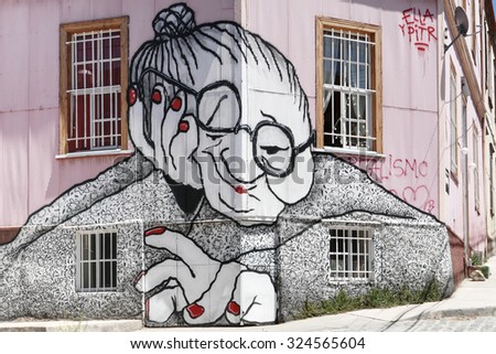 VALPARAISO, CHILE - OCTOBER 29, 2014: Graffiti of an old woman sprayed on a building facade in Valparaiso, Chile. Valparaiso Historic center is a UNESCO world heritage site