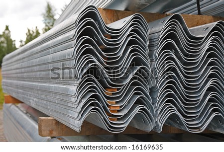 Huge piles of aluminum painted steel profiles for construction work