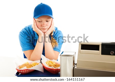 Unhappy teenage girl has a boring job serving fast food.  Isolated on white.