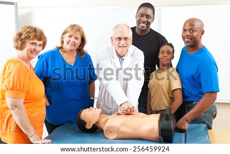 Adult education class learning CPR first aid from a doctor.