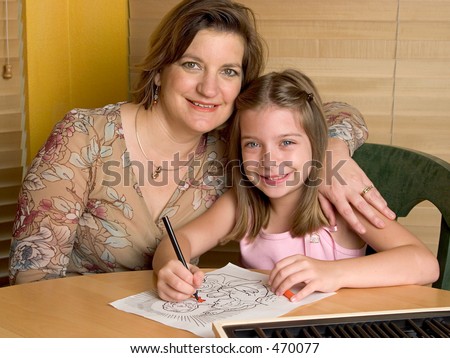 A mother and daughter coloring a picture of Jesus.