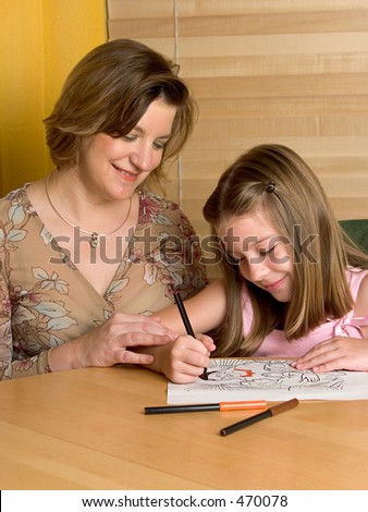 A woman teaching a little girl in Sunday School.