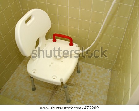 a medical shower chair and spray shower head for injured or disabled people