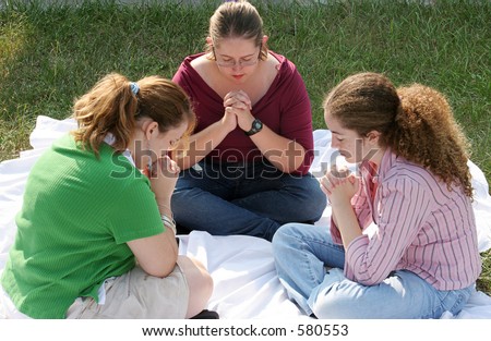 A group of teen girls gathered for prayer.