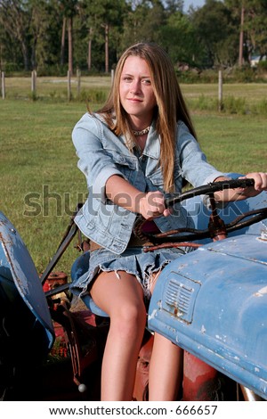 A Beautiful Blond Country Girl Driving A Tractor. Stock Photo 666657 ...