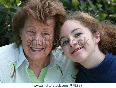A closeup portrait of a sweet grandmother and cute teen granddaughter.