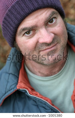 A closeup portrait of a homeless man.  Shallow depth of field, with focus on his left eye.