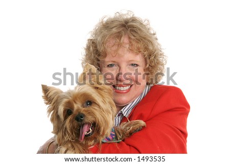 A pretty red-haired woman holding her adorable pet yorkshire terrier.