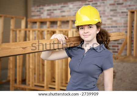 A young female apprentice working on a construction site.