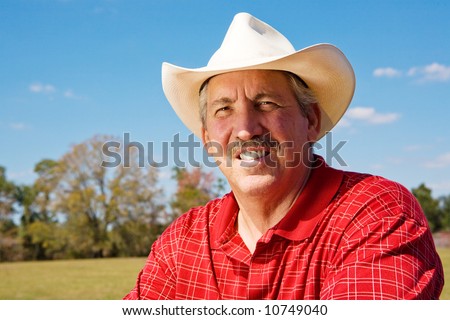 Portrait Of A Handsome, Mature Cowboy On His Ranch. Room For Text ...