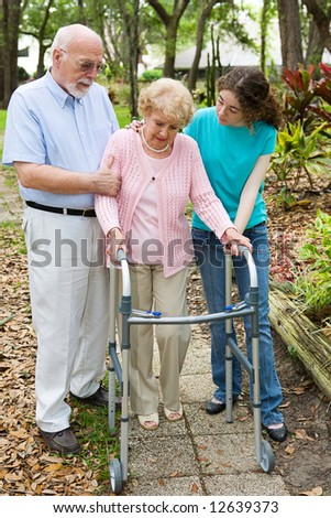 Senior woman depressed about her disability, being comforted by her family.