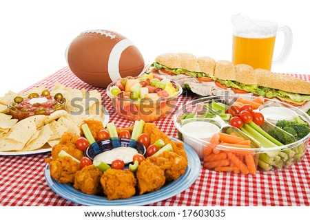 Table spread with appetizer trays for the footbal party.  Horizontal view over white background.