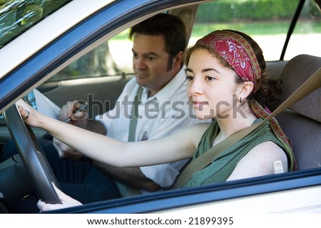 Teen girl taking driving test to get her drivers license.