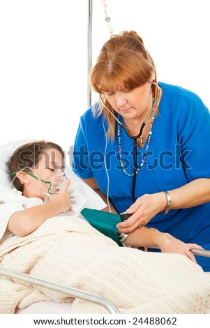 Friendly nurse takes the blood pressure of a sick little boy in the hospital.