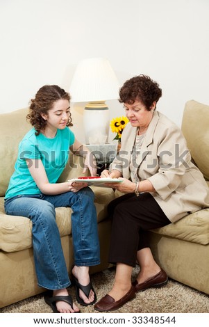Teen girl and older woman filling out paperwork during an interview. Could be counseling session or job application.  Vertical with copyspace.