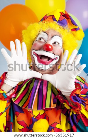 Adorable birthday clown making a jazz hands gesture.