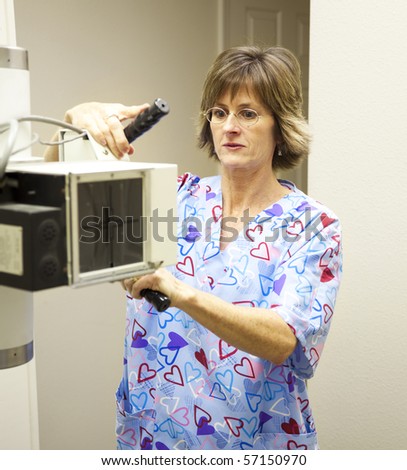 Radiology technician sets up the x-ray machine.