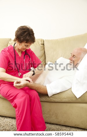 Home health nurse taking an elderly patient\'s pulse.