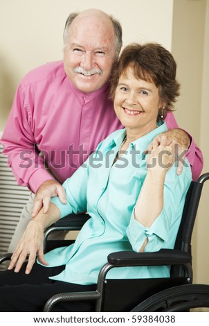 Happy mature couple in love.  The wife is in a wheelchair.