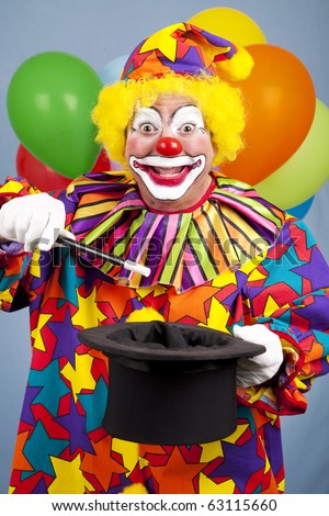 Happy birthday clown does a magic trick with a top hat and wand.