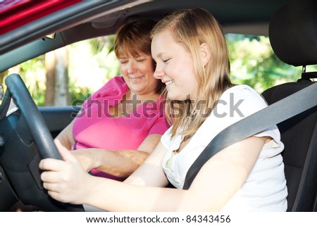Teenage girl eager to start a driving lesson with her mother or an instructor.