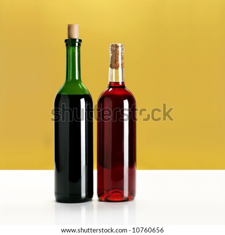 two bottles of wine on yellow background