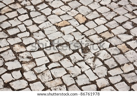 Portuguese cobblestone sidewalk made of cubic stones