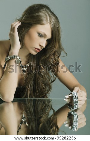 Portrait of a beautiful woman with jewelry and evening make-up