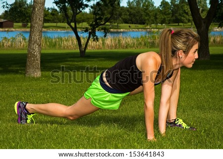 Young woman stretching her hamstring muscle.