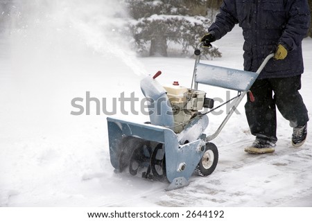 Man removing snow with a snow blower.
