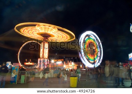 Fair grounds at night with ferris wheel, and Yo-yo ride