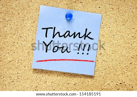 Thank You on blue sticky note pinned with blue push pin on cork board