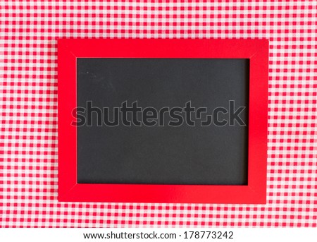 A menu card chalkboard on gingham background. Space for text.
