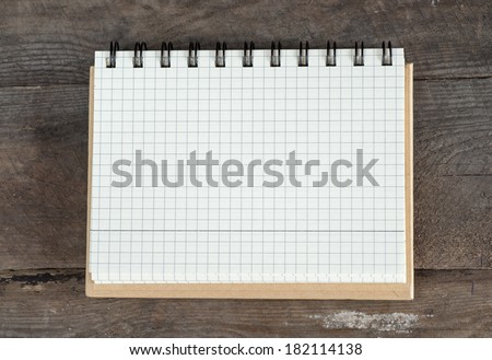 Memo pad on a well used old wooden surface