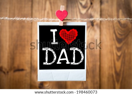 I love Dad message written on old photo on hanging on rope with wooden wall