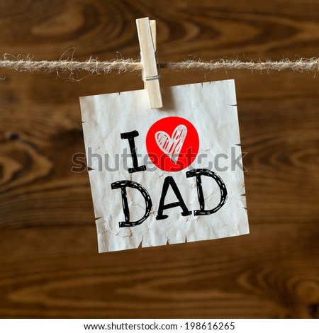 I love Dad message written on a aged paper handling on rope with hearts