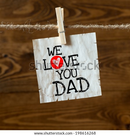 We love you Dad  message written on a aged paper handling on rope with hearts