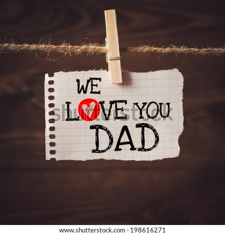 We love you Dad  message written on a aged paper handling on rope with hearts