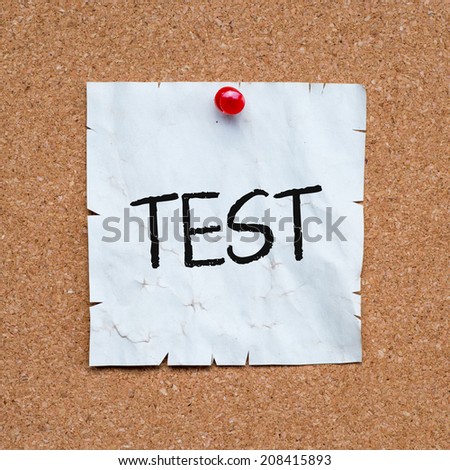 Test word made of post it note paper on cork board