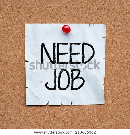 Need job written on an sticky note pinned with red push pin on cork bulletin board.