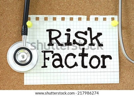 Risk Factor handwritten on paper note with stethoscope on wooden table