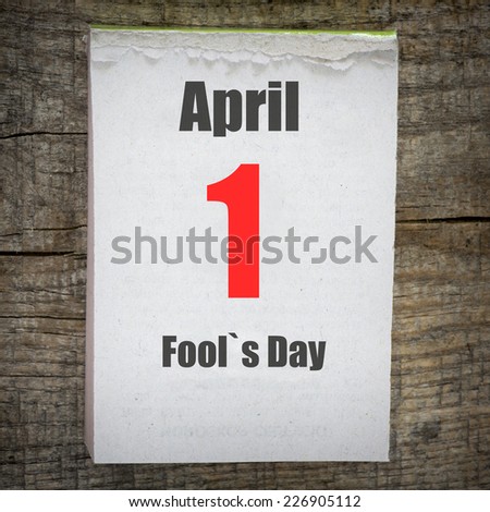 Calendar on old wooden wall. 1 April, Fool`s Day.